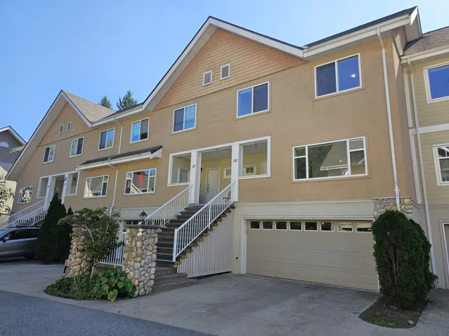 View of front of house featuring stairs, stucco siding, driveway, and an attached garage