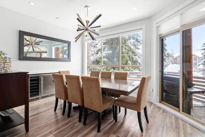 Dining space featuring recessed lighting, a chandelier, light wood-style floors, and beverage cooler
