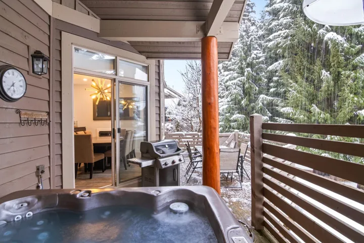 View of patio / terrace with area for grilling, a hot tub, and a balcony