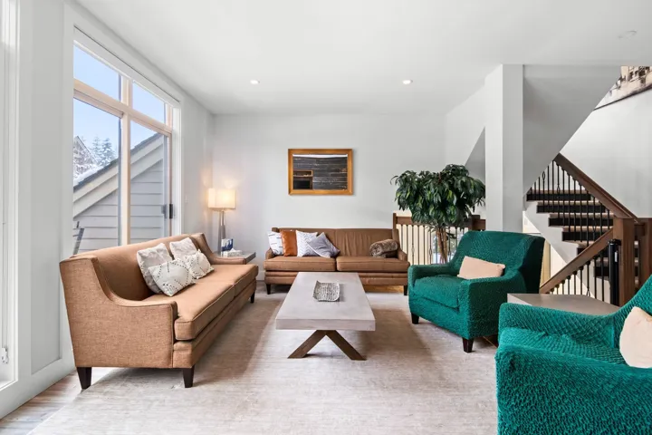 Living area featuring wood finished floors, stairway, and recessed lighting
