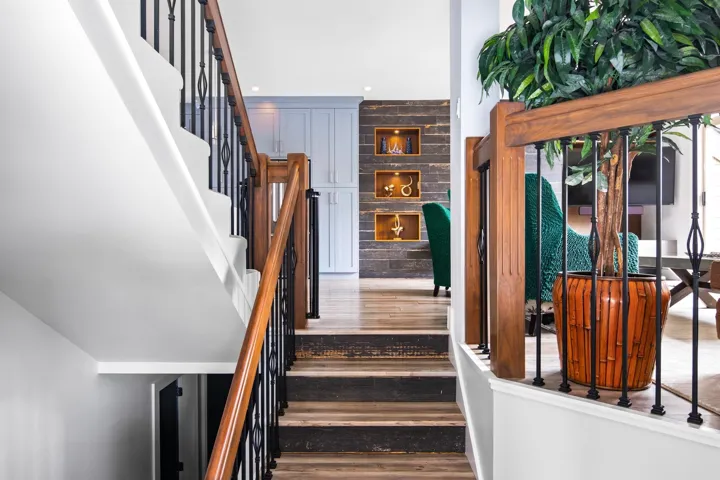 Stairway featuring wood finished floors
