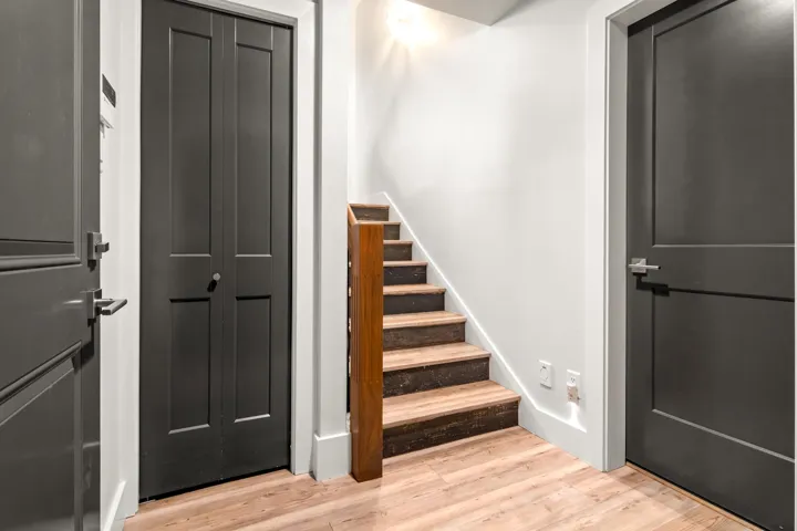 Stairs featuring wood finished floors