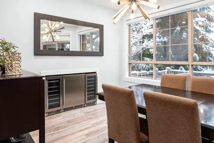 Dining room with wine cooler and wood finished floors