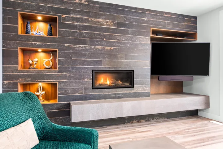 Details featuring a glass covered fireplace, baseboards, and wood finished floors