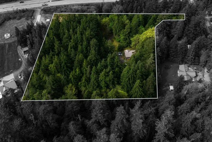View of property location featuring a heavily wooded area and property parcel outlined