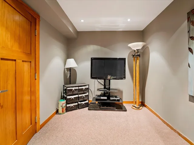 Exercise room featuring baseboards, recessed lighting, and carpet