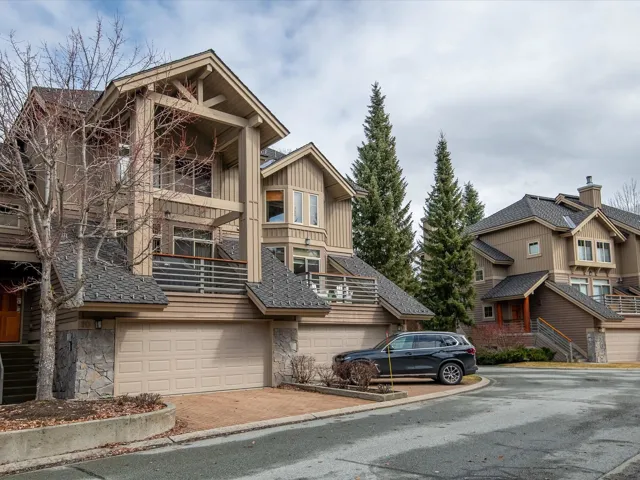 View of building exterior with driveway and an attached garage