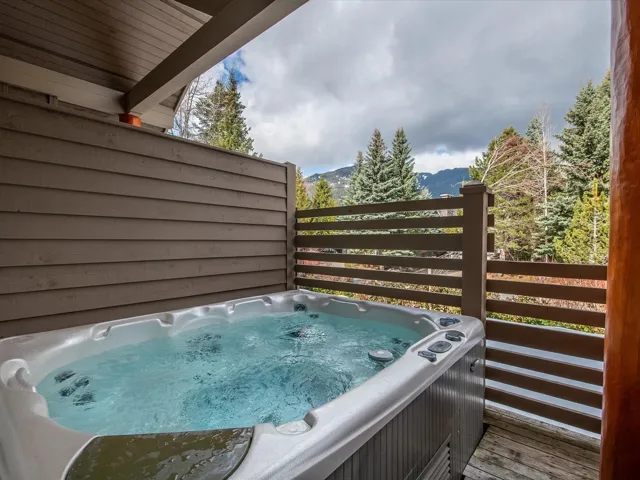 Exterior details featuring a jacuzzi and a mountain view