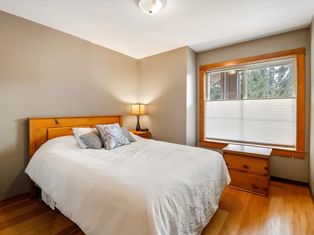 Bedroom featuring baseboards and wood finished floors
