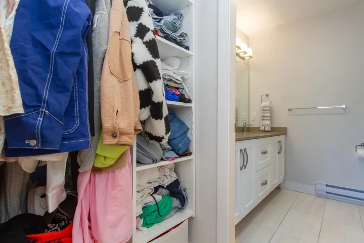 Bathroom featuring tile patterned flooring, baseboards, a baseboard heating unit, and vanity
