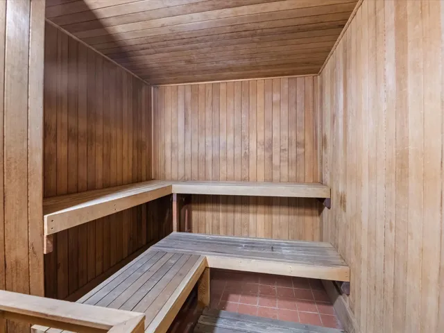 Sauna with wooden ceiling and tile patterned flooring