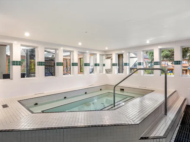 View of swimming pool featuring an in-ground hot tub