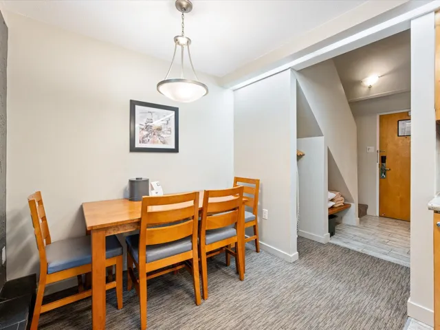 Dining room featuring light colored carpet and baseboards