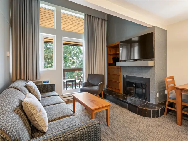 Living area featuring a tile fireplace