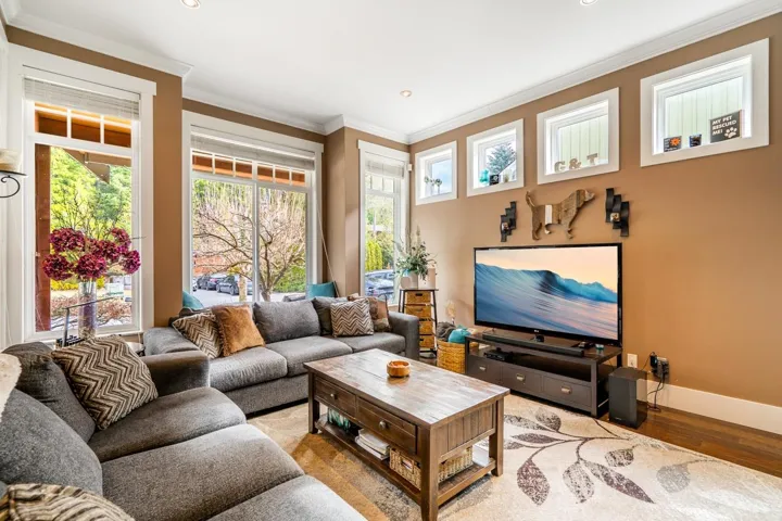 Living area with ornamental molding, wood finished floors, and recessed lighting