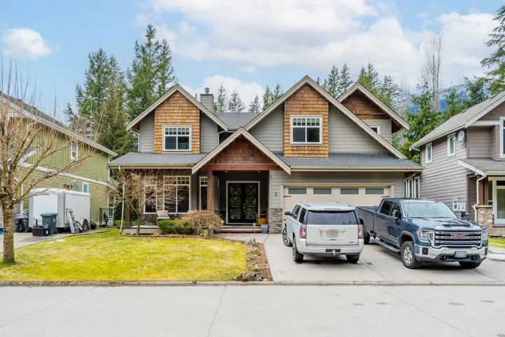Craftsman house with concrete driveway, a front yard, a chimney, an attached garage, and roof with shingles