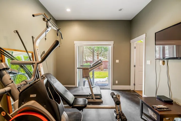 Exercise area featuring rubber floors and recessed lighting