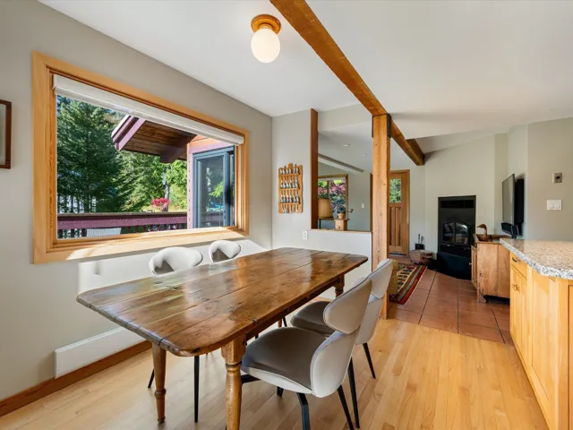 Dining room featuring light wood-style floors and beamed ceiling