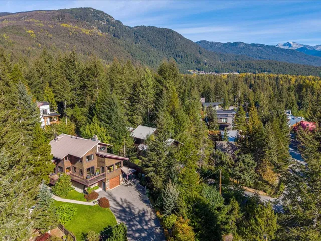 Aerial view of property and surrounding area with a mountain backdrop