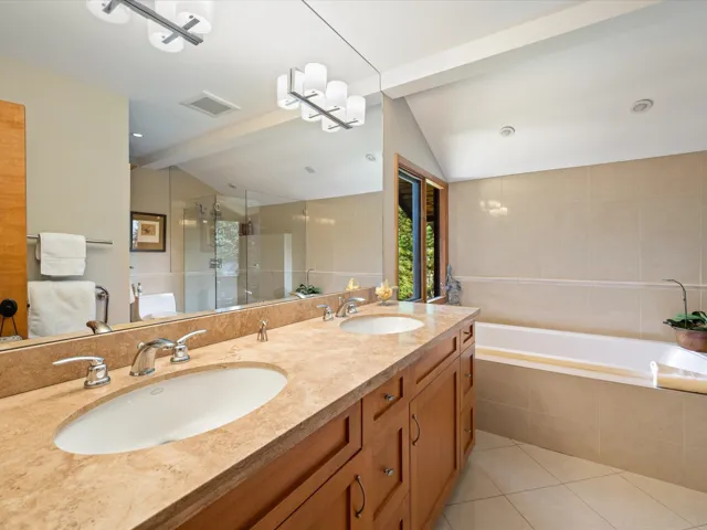 Bathroom with a stall shower, double vanity, light tile patterned floors, and a bath