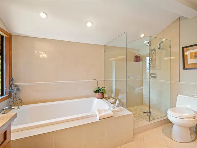 Full bath with tile walls, a bath, a stall shower, vanity, and tile patterned flooring