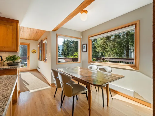 Dining room with light wood-style floors, baseboard heating, and wood ceiling