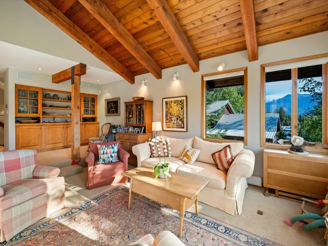 Living area featuring carpet flooring, wood ceiling, and a mountain view