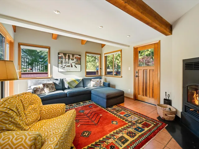 Living room with beamed ceiling, light tile patterned flooring, healthy amount of natural light, and recessed lighting