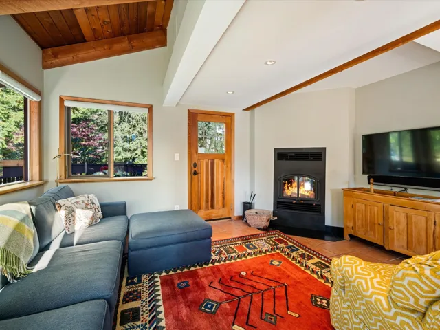 Living area featuring light tile patterned flooring, a fireplace with flush hearth, and recessed lighting