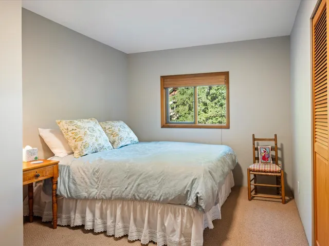 Bedroom featuring light carpet