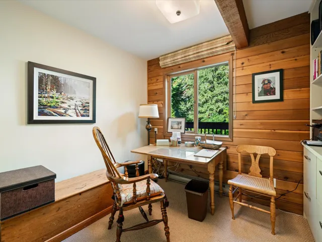 Home office featuring wooden walls, beam ceiling, and baseboard heating