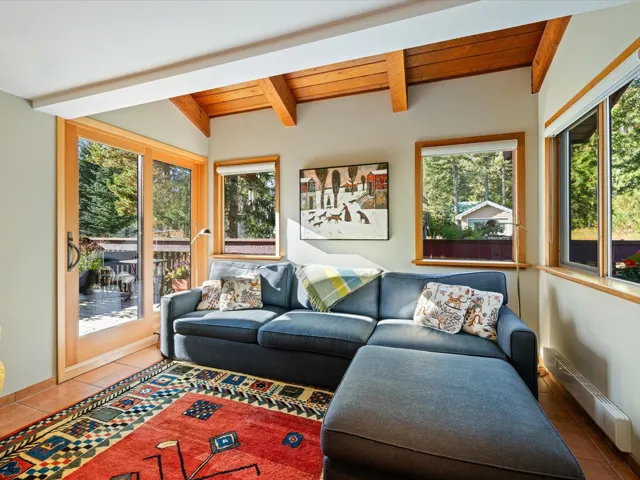 Living area featuring wooden ceiling, tile patterned floors, and baseboard heating