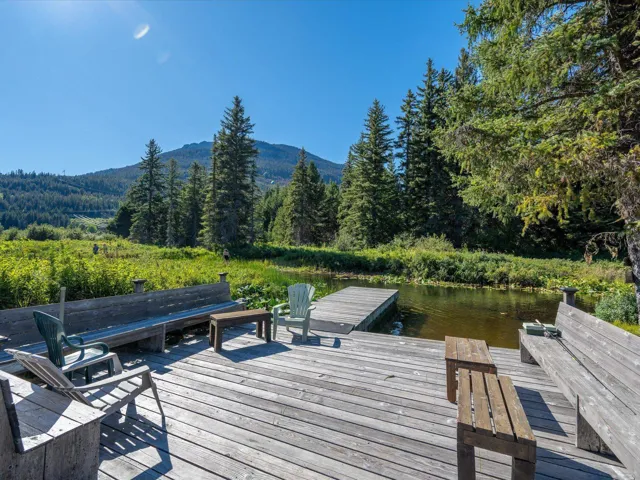 Dock featuring a view of trees and a water and mountain view
