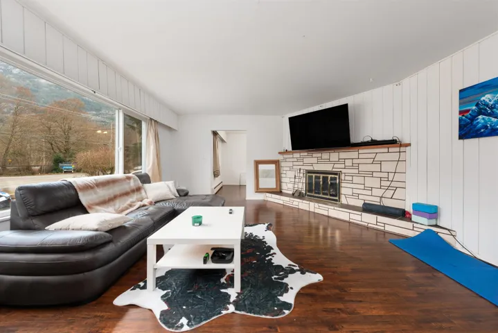 Living room with a fireplace and wood finished floors