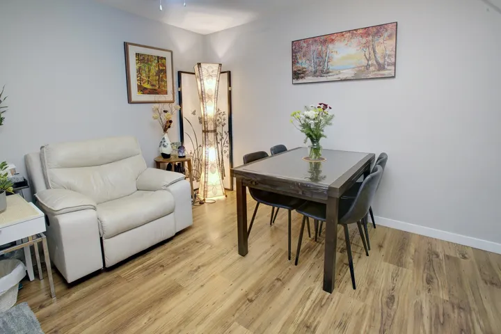 Dining space with light wood-style floors and baseboards