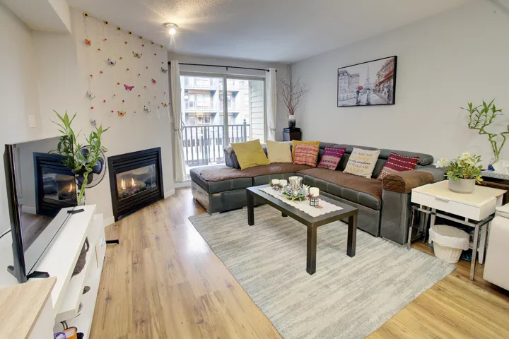 Living room featuring a glass covered fireplace and light wood-type flooring