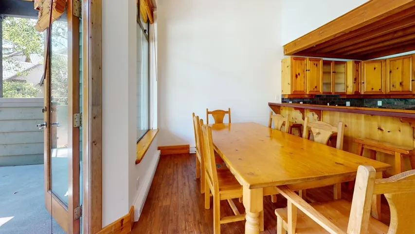 Dining area with wood finished floors and a baseboard radiator