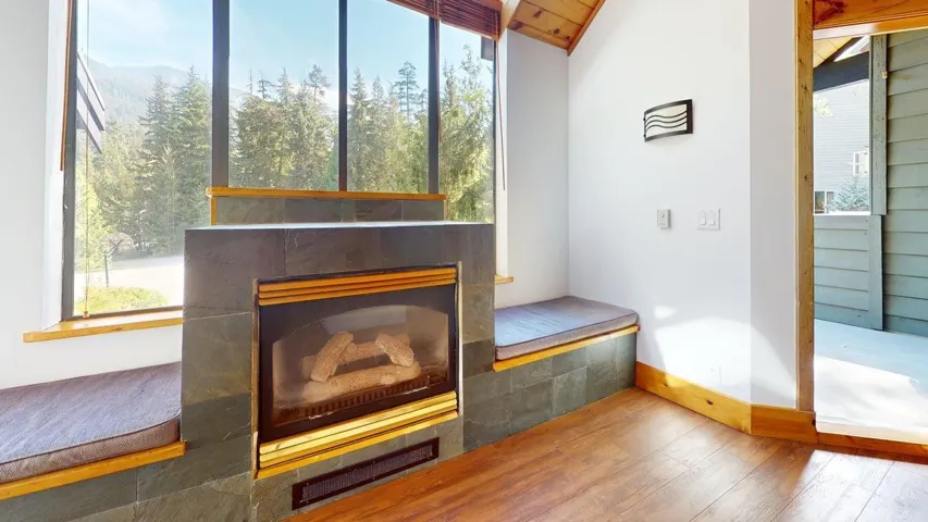 Detailed view of wood finished floors and a tiled fireplace