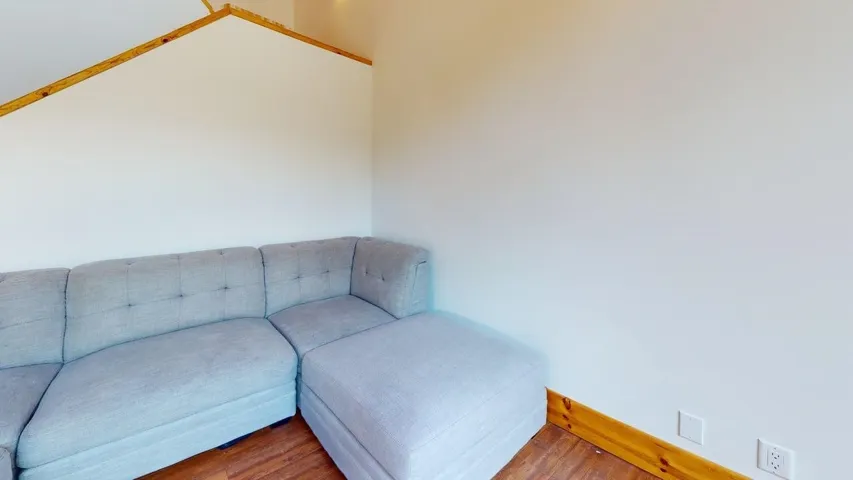 Sitting room with wood finished floors and baseboards