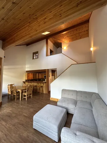 Living room with wood ceiling and dark wood-style floors