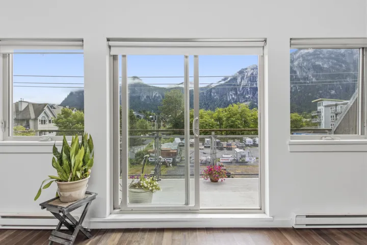 Expansive sliding glass doors provide access to an outdoor balcony