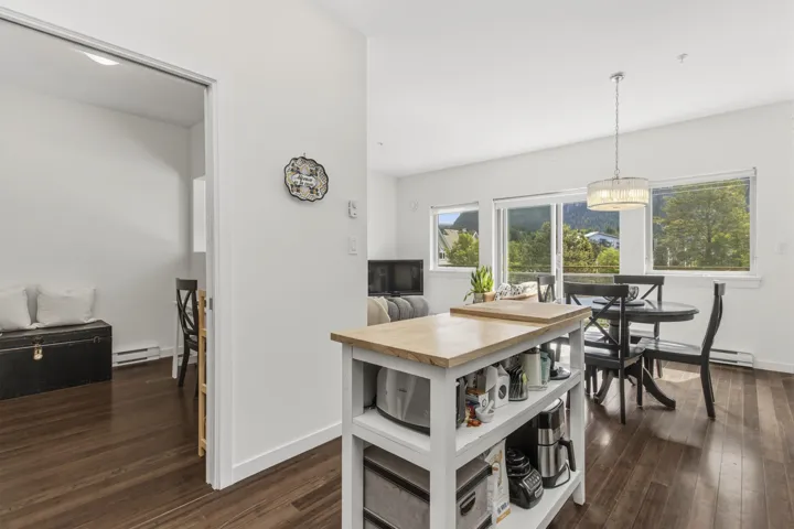 Open-concept living area with dark wood-finish flooring
