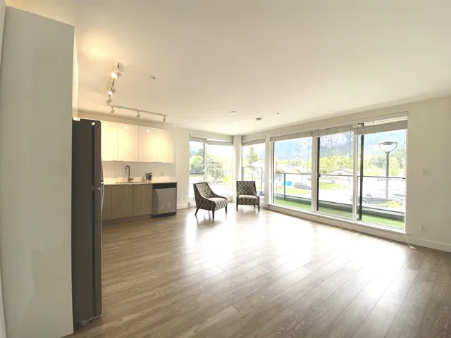 Living room featuring wood finished floors and rail lighting