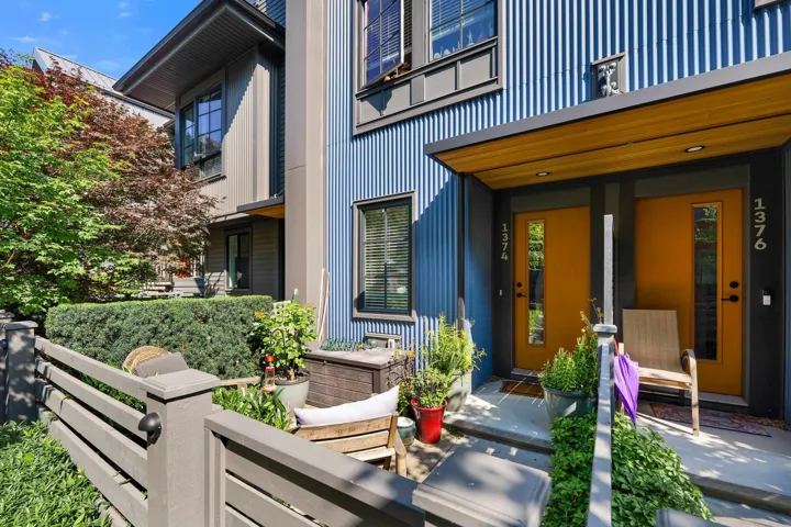 Contemporary exterior featuring vertical corrugated siding, wood-look soffits, and a flat roofline
