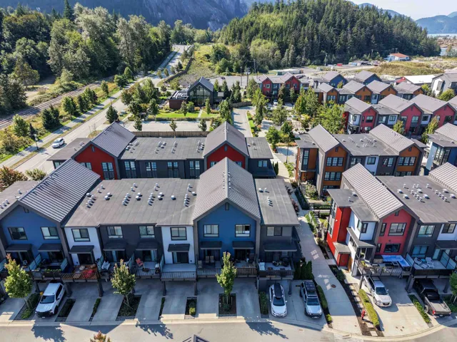 Modern townhome community featuring diverse exterior finishes, private balconies, and dedicated parking