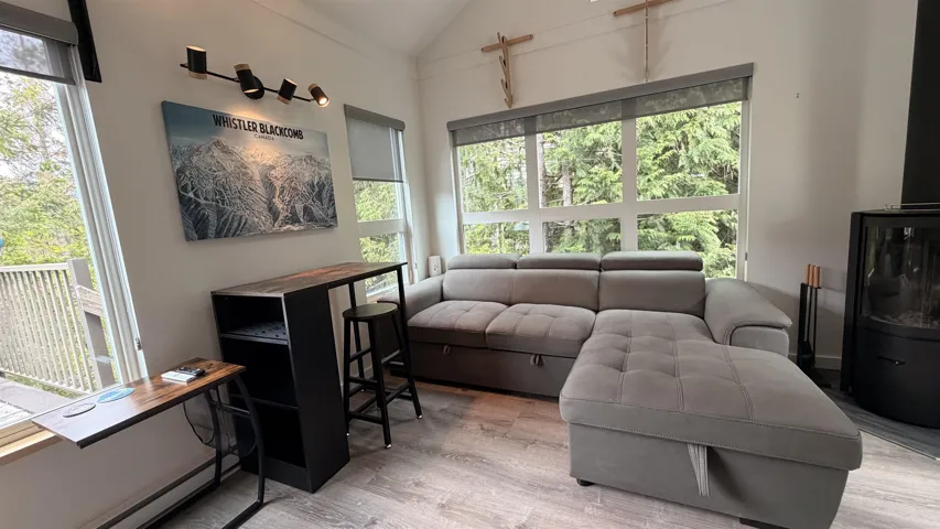 Living area featuring vaulted ceilings and wood-finish flooring