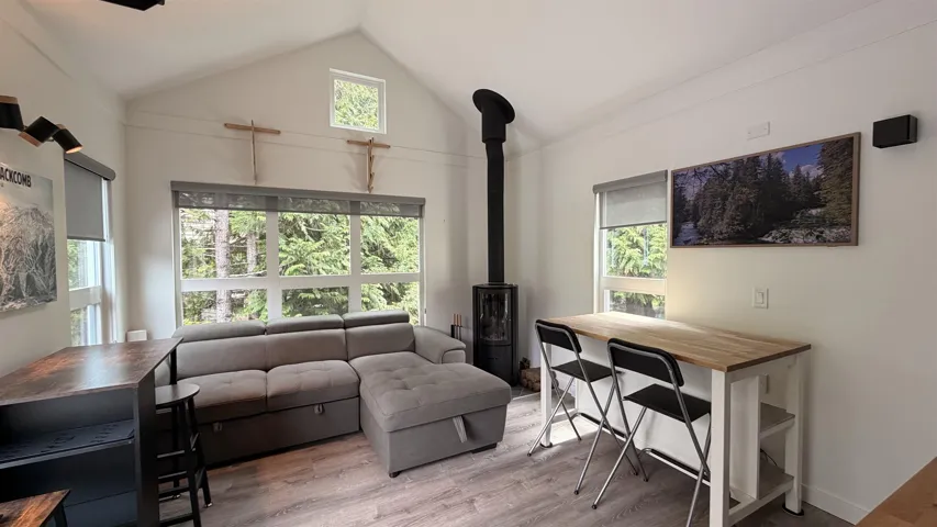 Vaulted ceilings and wood-finish flooring define this living space