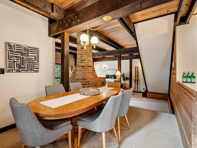 Dining space with wood ceiling, beam ceiling, and an inviting chandelier