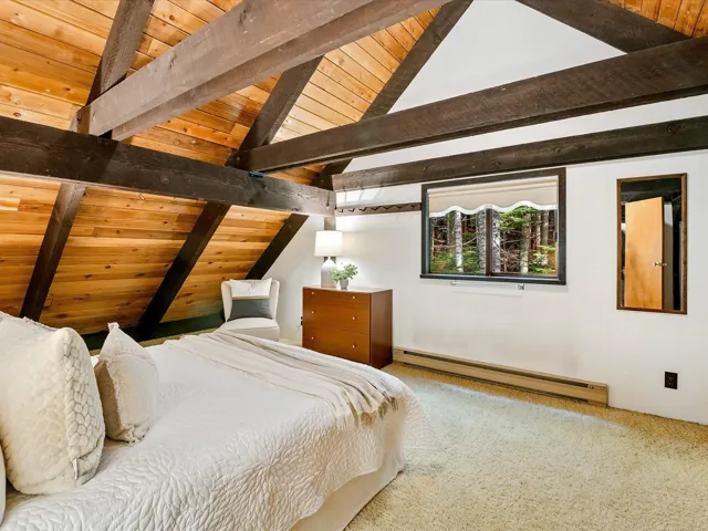 Bedroom with baseboard heating, carpet, and wooden ceiling