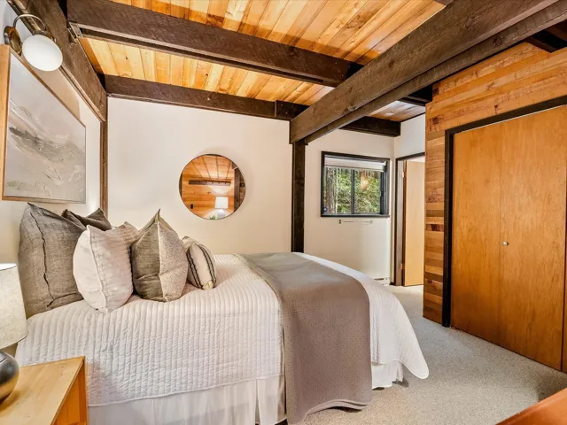 Bedroom featuring wooden ceiling, beam ceiling, and carpet flooring